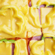Overhead view of pizza covered in glossy melted slices of American cheese